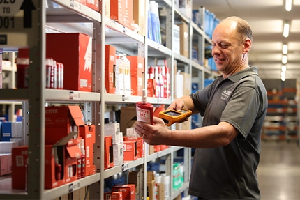 Acorn operative scans a Loctite barcode to put into stock